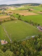 Sports field with neighbouring fields and trees near a village, VFL Stammheim, Calw, Black Forest,