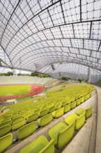 Stadium interior with yellow seats and an elegant roof design, Olympiapark, Munich, Germany