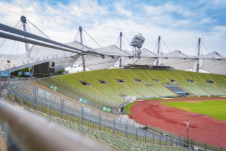 Exterior view of the stadium with striking tent structure and red running track, Olympic Park,