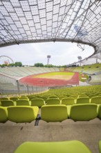 Empty modern stadium with central view of running track and striking glass architecture,