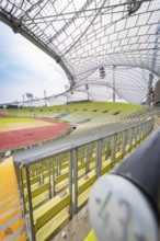 Close-up in the stadium with empty seats and striking roof construction, Olympiapark, Munich,