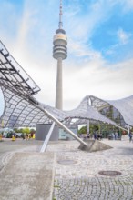 Impressive architecture below a television tower with modern design under a blue sky, Olympic Park,