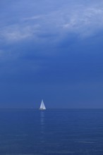 Sailboat off Falckenstein, dark clouds, Kiel Fjord, Kiel, Schleswig-Holstein, Germany