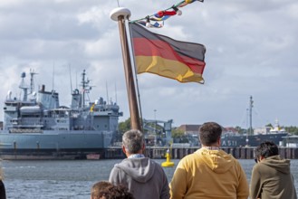 Toruists on excursion boat, flag, Bundeswehr ships, naval base, Kiel, Schleswig-Holstein, Germany