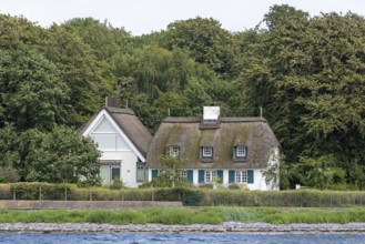 Thatched-roof houses on the shore, Kiel Fjord, Schleswig-Holstein, Germany