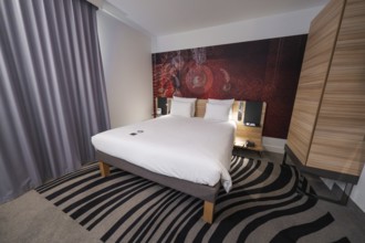 Cosy hotel room with modern design, elegant curtains and creative carpet pattern, Munich, Germany