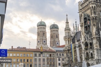 City view with historic buildings and church towers under a cloudy sky, Munich, Germany