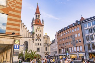 Tower and busy street in Munich with people passing by in nice weather, Munich, Germany