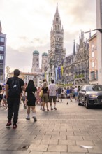 Lively street scene on Marienplatz with striking building towers, Marienplatz, Munich, Germany