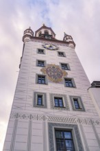 Decorated tower with clock in front of a pink cloudy sky, Munich, Germany