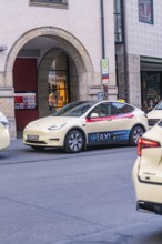 Tesla e-taxi parked in an urban environment, Munich, Germany