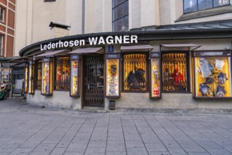 Illuminated shop window of a traditional lederhosen shop, Munich, Germany