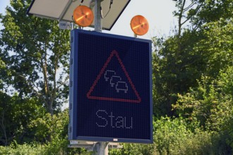 Traffic sign with solar-powered traffic jam warning on the motorway, Baden-Württemberg, Germany