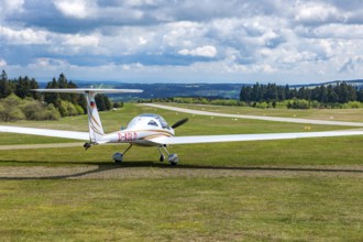 Motorised glider taxiing to the runway at Wasserkuppe airfield, Rhön, Gersfeld, Fulda district,