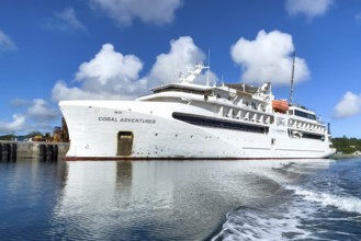 Small cruise ship Coral Adventurer moored in the harbour of Colonia capital of Yap Island, Pacific