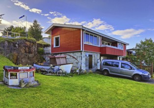 Front garden with old boats as decoration and mowed lawn, Vopnafjördur, East Iceland, Iceland