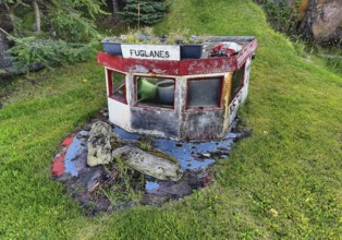 Front garden with old boat top as decoration and mown lawn, Vopnafjördur, East Iceland, Iceland
