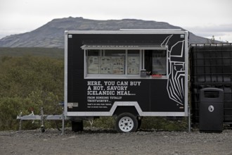 Food truck in the car park at Brúarfoss waterfall in the countryside with opening hours from 11 am