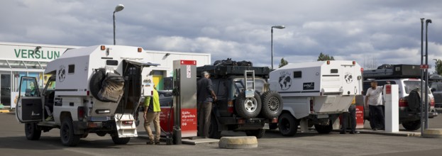 Several off-road vehicle drivers refuelling at self-service petrol stations, Reykjalith, Myvatn,