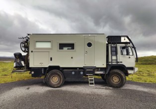 Large camping vehicle parked in a car park on the Kaldidalur slope, Highlands, Iceland