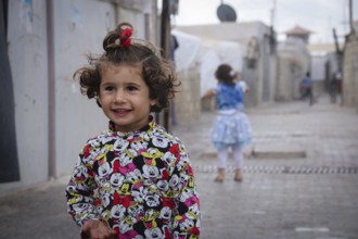 A Syrian refugee child photographed in a camp, reflecting the harsh living conditions of displaced