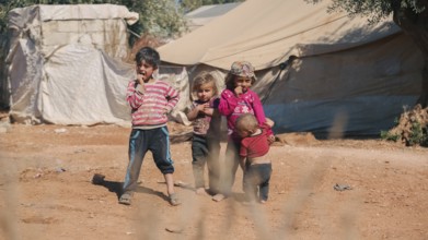 Syrian children playing in a refugee camp near the Turkish border on World Children's Day. Aleppo,