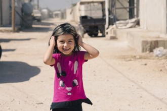 A Syrian refugee child photographed in a camp, reflecting the harsh living conditions of displaced