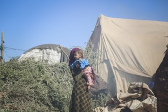 A Syrian refugee child photographed in a camp, reflecting the harsh living conditions of displaced