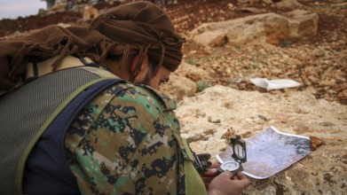 Syrian opposition fighters planning military strategies in preparation for clashes with ISIS.