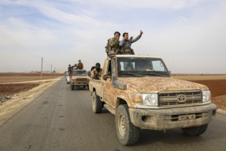 Fighters from the Free Syrian Army celebrate victory after capturing villages that were under the