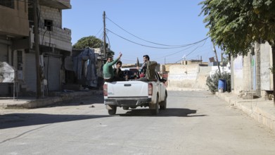 Fighters from the Free Syrian Army celebrate victory after capturing villages that were under the