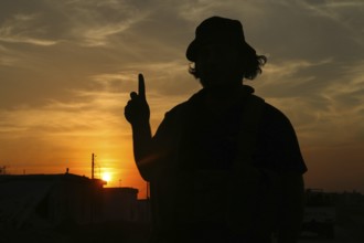 Silhouette of a Syrian armed opposition fighter at sunset, during the war against the PKK. Aleppo,