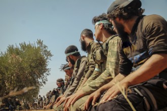 Free Syrian Army fighters praying on the battlefield during combat against terrorist organizations