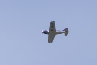Alpi Pioneer 300 light aircraft flying in a blue sky, England, United Kingdom