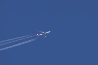 Boeing 747 jumbo jet cargo aircraft of Cargolux airlines with a vapour trail or contrail flying in