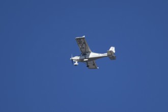 Evektor SportStar light aircraft flying in a blue sky, England, United Kingdom