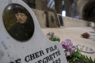 WWI soldier's portrait at necropolis with graves of Belgian World War One soldiers buried in the