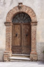 Old wooden entrance door, Montalcino, Province of Siena, Tuscany, Italy