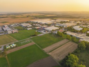 View of an industrial area surrounded by agricultural land in the evening light, Wolfsberg Nagold
