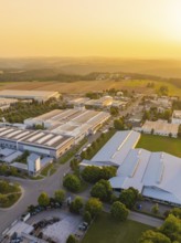 Industrial area at sunset with fields and green areas in the background, industrial area Wolfsberg