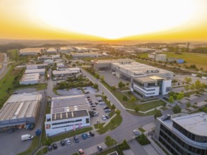 Spacious industrial estate at sunset with organised streets and modern buildings, Wolfsberg Nagold
