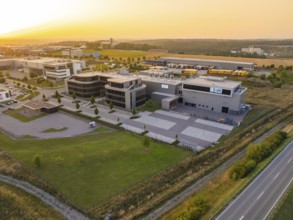 Commercial area with modern buildings and streets in a rural setting in the evening, industrial