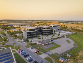 Modern office buildings and car parks in an urban setting at sunset, Wolfsberg Nagold industrial