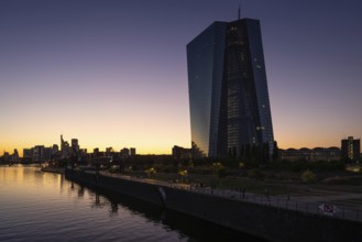 The sun sets behind the European Central Bank (ECB) and the Frankfurt banking skyline, Frankfurt am