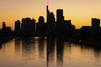 The sun sets behind the Frankfurt banking skyline, Frankfurt am Main, Hesse, Germany