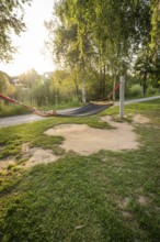 A hammock between trees in a green park at sunset, Nagold, district of Calw, Black Forest, Germany