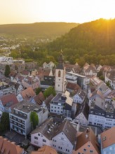 Bird's eye view of an urban area with church tower and hills in the evening light, Nagold, district