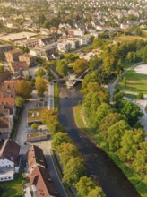River with bridges and surrounding parks and autumn trees photographed from a bird's eye view,