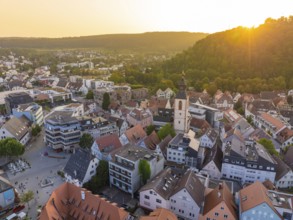 Evening view of an old town with church tower, surrounded by nature and hills, Nagold, district of