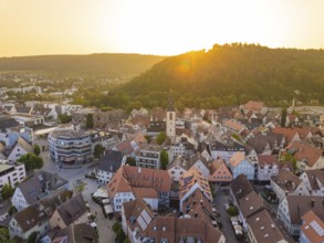 View of an old town with church and hills in the background at sunset, Nagold, district of Calw,